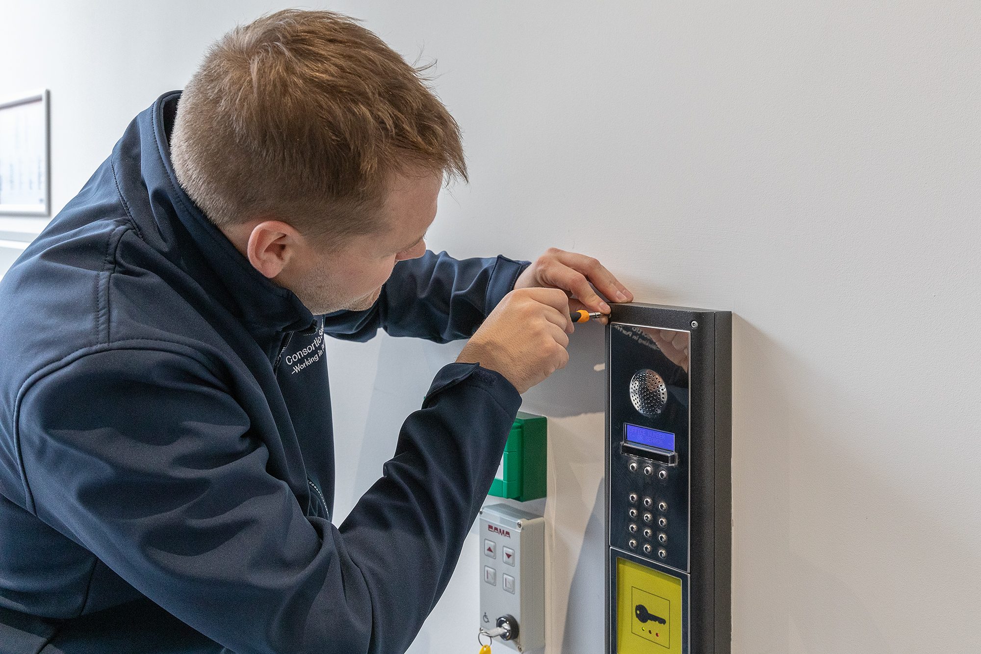 man fixing security box